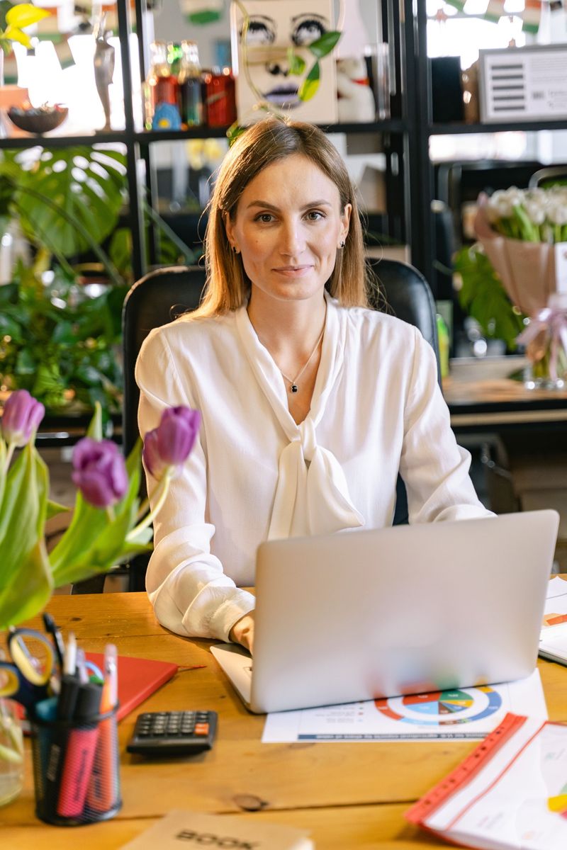 Private investor at her desk with a laptop and financial reports