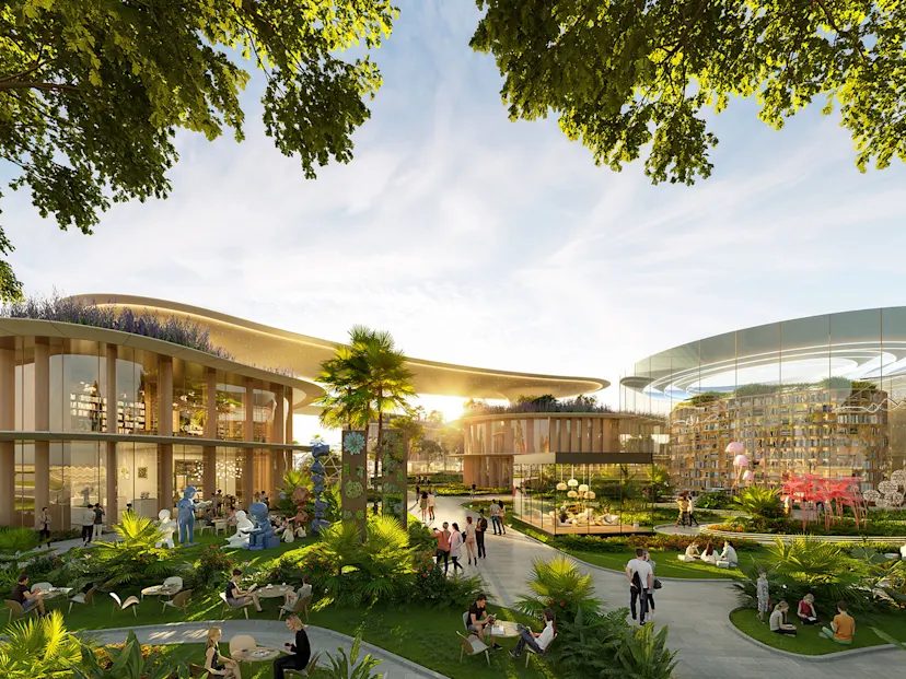 Tree-lined plaza with cafés and a glass library pavilion at DAMAC Islands 2