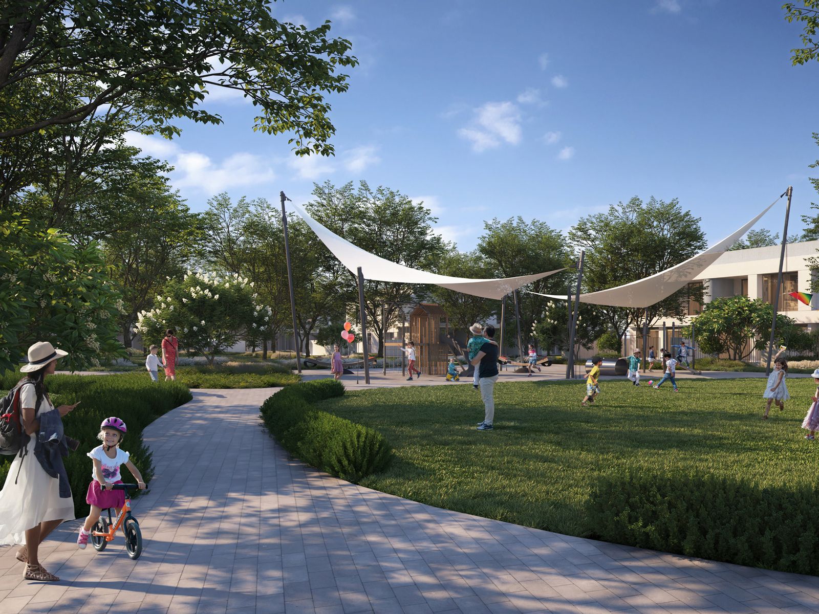 Families and children at a community park with shaded play area at The Valley