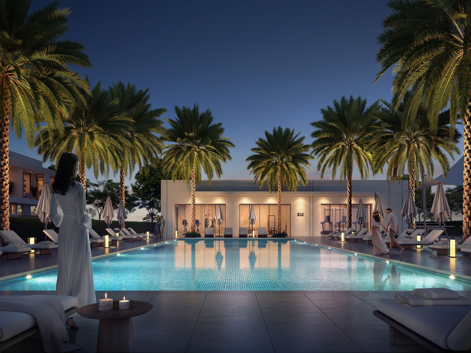 Landscaped pool deck lit at night at The Valley