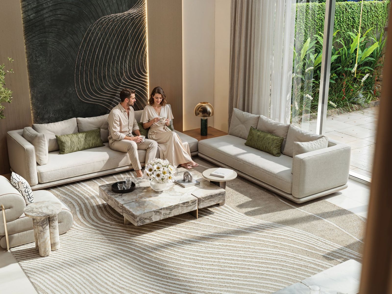 Couple seated in a living room opening onto a garden at Tilal Binghatti