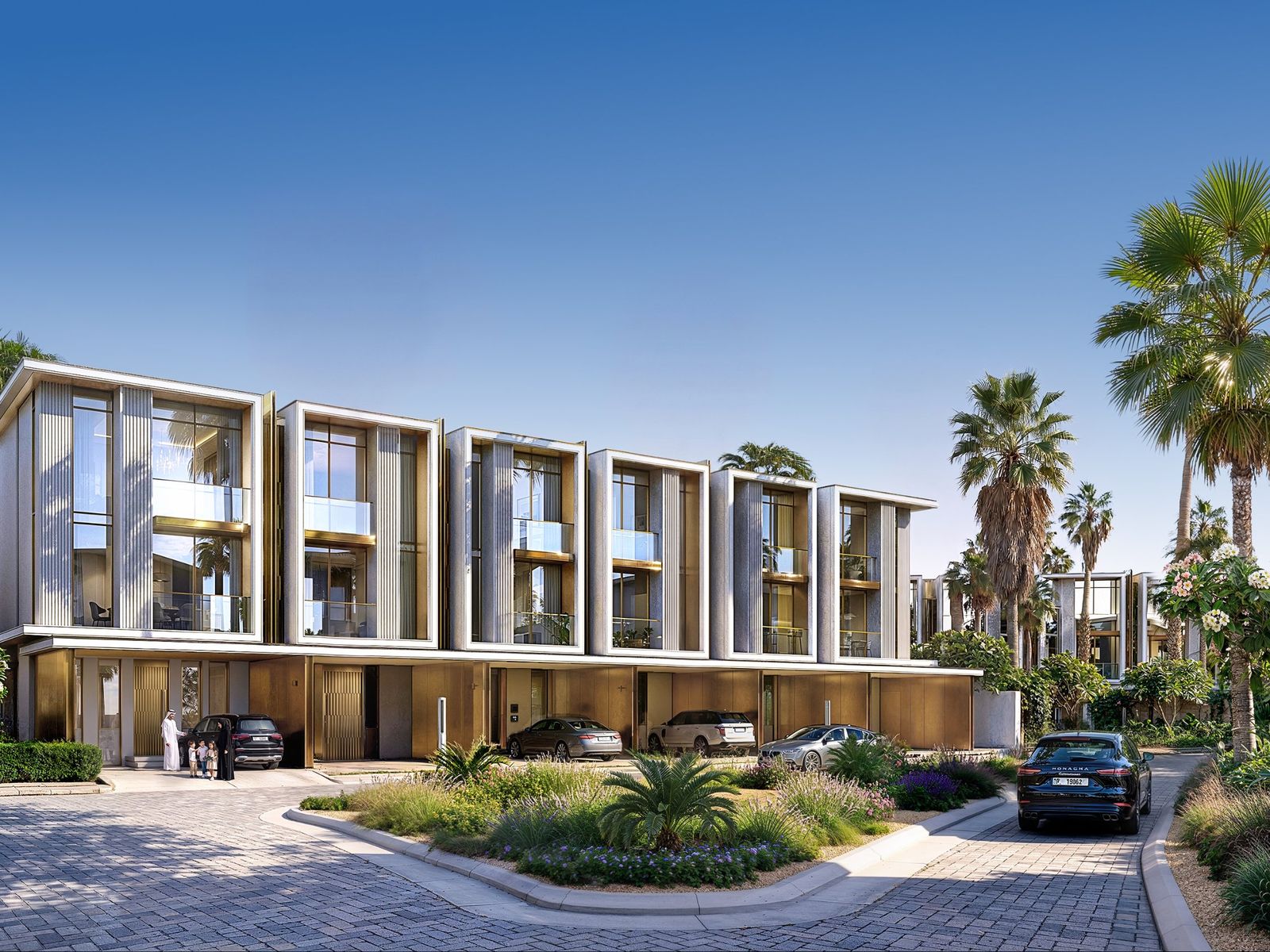 Row of Tilal Binghatti townhouses with gold-toned façades around a landscaped courtyard, Dubai