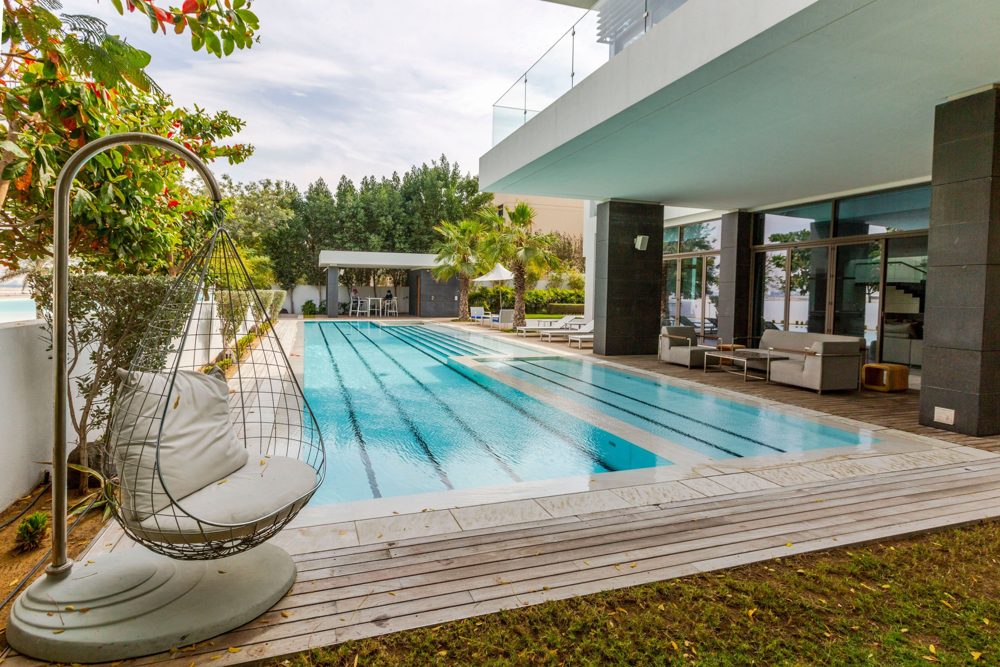 Pool and shaded seating area of the same completed villa